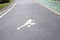 The white jogging man painting on the jogging lane parallel with green bike lane.