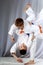 In white judogi two athletes are training throws