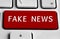 White keyboard with Fake news button