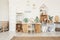 White kid room interior with gold posters on the wall, toys and