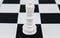 White king placed on top of a black square of the chess board in a game