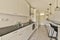 a white kitchen with black counter tops and a sink