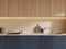 White kitchen with blue cabinets and wooden cupboards