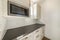 White kitchen interior with alcove sleek dark gray kitchen countertop