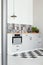 White kitchen interior with elegant wooden cupboards and kitchen accessories