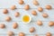 white kitchen table texture background with fresh yellow yolk egg on white cup. view from top table.