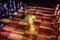 White knight staying against full set of black chess pieces. Closeup of chessboard with wooden pieces on table in sunlight, game