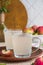 White kvass, a fermented drink made from apples in glass mugs on a light concrete background. Fermented foods, probiotics