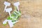 White labels-markers for plants lie on burlap, on wooden  background.