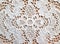 White lace doily Plauener spitze (Plauen lace) closeup on wooden background