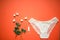 White lace panties with tampon on a coral background. Female underwear for the bride with delicate flowers on an orange background