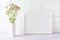 White landscape frame mockup creamy pink flowers in cylinder vase