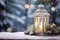 White lantern with candle and decorations on snow