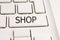 white laptop computer keyboard with the words shop on the key