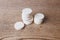 White large pills close up stand in a pile on a wooden background. Vitamins, pharmaceuticals for the treatment of diseases