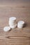 White large pills close up stand in a pile on a wooden background. Vitamins, pharmaceuticals for the treatment of diseases