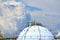 White large storage tanks under a blue sky.