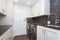 White laundry room boasts white shaker cabinets