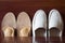 White leather slipper or shoes with orthopedic insoles. Wooden b