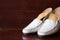 White leather slipper or shoes with orthopedic insoles. Wooden b