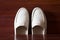 White leather slipper or shoes with orthopedic insoles. Wooden b