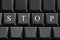 The white letter of Stop on computer keyboard background.