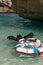 White Life Preservers on Clear Sea Near Steep Cliff