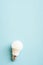 White light bulb on blue background