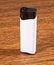 White lighter on wooden background.