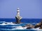 The white lighthouse of Andros island, in the Cyclades, Greece