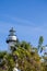 White Lighthouse on Blue Beyond Green