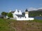 White lighthouse and keeper`s cottages