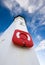 White lighthouse with lifering and blue skies