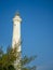 A white lighthouse rising out of tropical vegetation