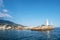 The white lighthouse tower at the entrance to the seaport of Yalta