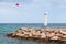 White lighthouse tower mounted on breakwater