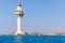 White lighthouse and traffic control tower. Jeddah, Saudi Arabia