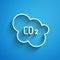 White line CO2 emissions in cloud icon isolated on blue background. Carbon dioxide formula, smog pollution concept