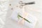 White linen napkin, trimmed with handmade lace, rolled in several layers, delicate snowdrop flower, scissors, buttons, ribbon is