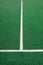 White lines on green soccer or football field. Perpendicular lining.