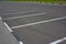 White lines of marking on a background of gray asphalt parking