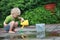 White little barefoot girl playing with water