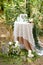 White little decorated wedding table near altar outside.