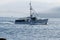 White lobster boat heads out to set traps with fogged in porcupine islands in the background