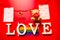 White love words, gay pride flag and bear with red heart