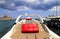 A white luxurious boat with red leather seats stands at the pier in the port