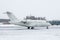 White luxury executive aircraft on the winter airport apron