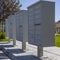 White mailboxes with shadows on the sidewalk