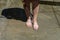 A white man hoses his feet with water on a hot summer day. Hosing feet