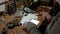 White man repairing a broken electronic led lamp in old workshop